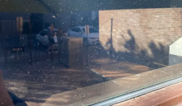 Office building windows with dirt and grime before commercial window cleaning in Mesa Arizona